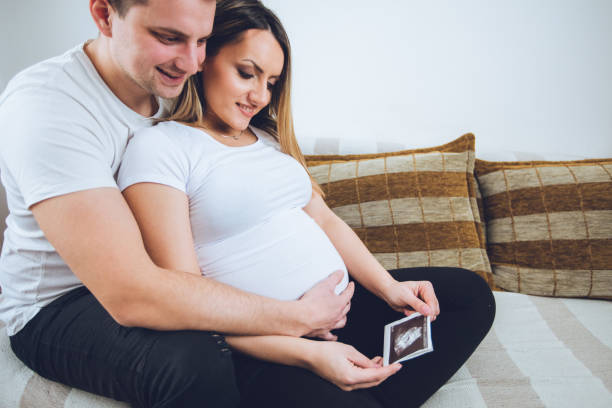 istock Happy couple watching ultrasound picture 1134937255