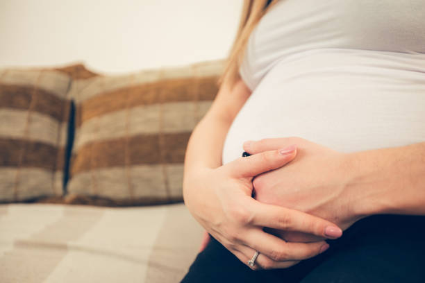 Close up of young future parents relaxing at home