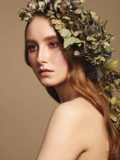 istock Beautiful young woman and flowers 1134938037