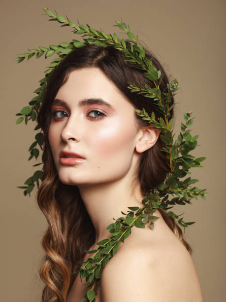 istock Young beautiful girl and leaves wreath 1134938063