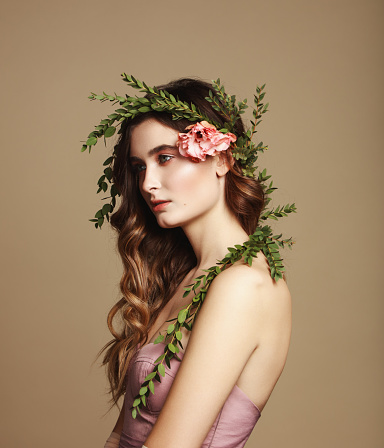 Portrait of beautiful and fresh girl with flower wreath