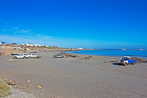 istock Vehicles and boat trailers parked on beach 1134938724