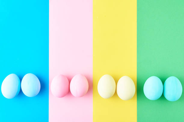istock Eggs on colored striped background, top view, minimalism concept 1134940261
