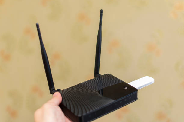 istock mobile usb modem to the router for the Internet, hold in your hand 1134941317