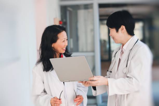 istock Two female scientist and doctor check the result 1134942456