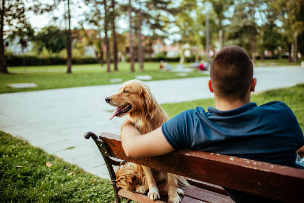 istock Man with his dog- public park. 1134945416