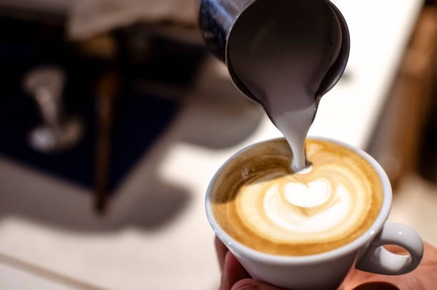 istock Pouring milk into espresso cup, making latte art 1134945741