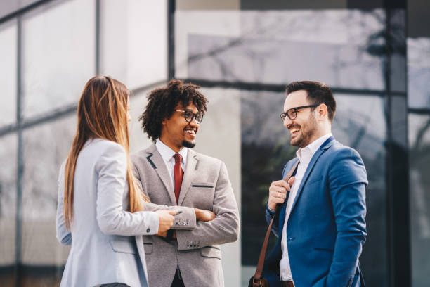 istock Happy business people walking outdoors and communicating. 1134945914