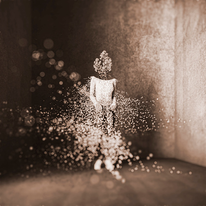Surreal exploding woman standing in concrete cube. This is entirely 3D generated image.