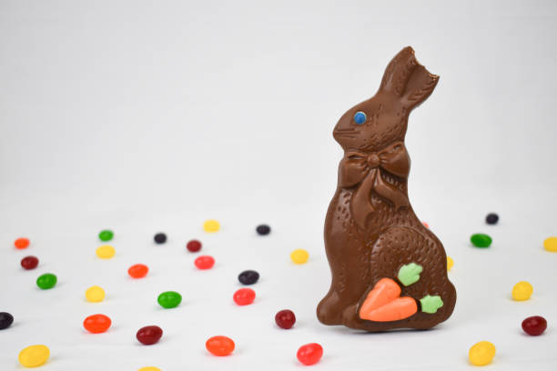 Chocolate Easter Bunny and Jelly Beans Candy on White Background Chocolate Easter Bunny and Jelly Beans Candy on White Background, Copy Space, Horizontal chocolate bunny stock pictures, royalty-free photos & images