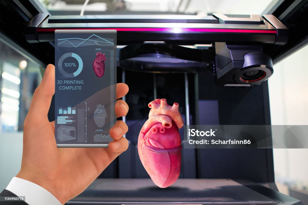 Application for printing human organs in a 3D printer. Hand with futuristic transparent smartphone. Application for printing human organs in a 3D printer. 3D Printing Stock Photo