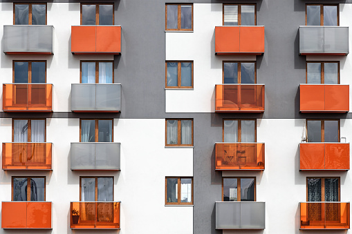 Facade of a colorful and modern multi-family building as a full frame background