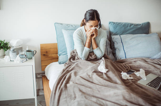 Flu attack Woman with flu in bed, she use home medicine to handle sickness cold and flu stock pictures, royalty-free photos & images