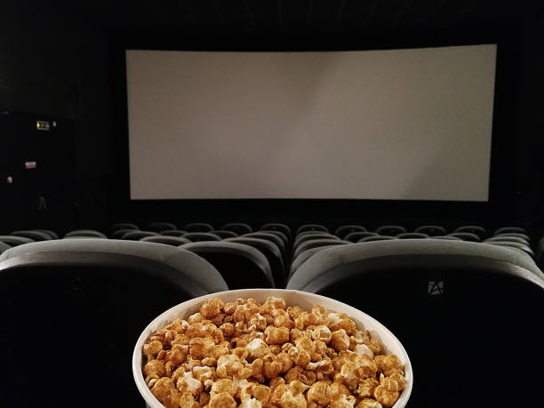 istock Cinema seat and pop corn facing empty movie screen 1134955153