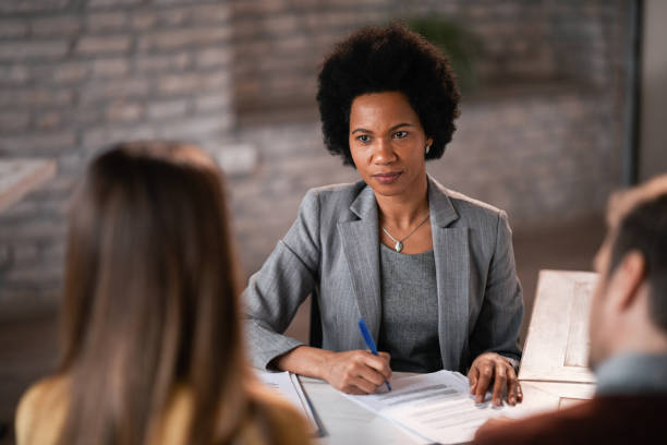 istock Black female financial planner taking notes while having a meeting with her clients. 1134955576