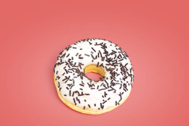 istock Sweet white donut isolated on red background 1134956804