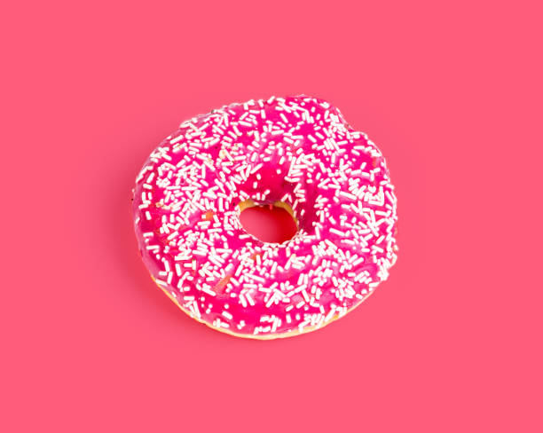 istock Sweet pink donut isolated on pink background 1134956813