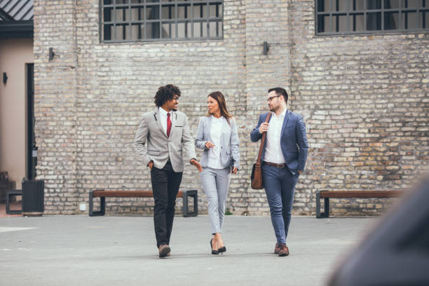 istock Group of business people walking talking. 1134959411