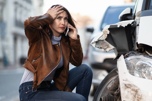 istock Young woman crying while calling for help after car accident. 1134960132