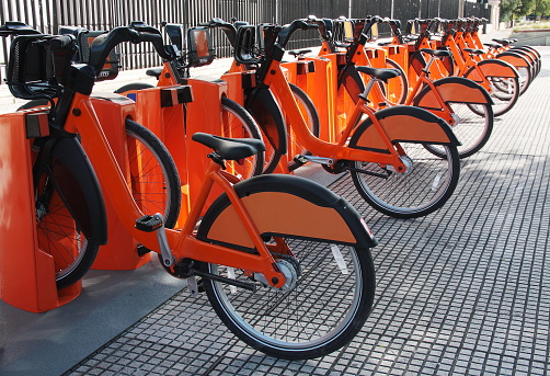 Electric bicycles parked at a bike sharing station