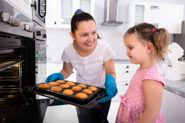 istock Mother Holding Cupcake While Looking At Her Daughter 1134962133