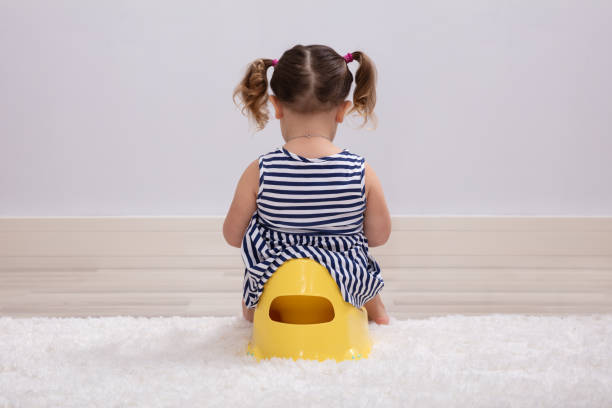 Female Toddler Sitting On A Potty Pot Rear View Of Female Toddler Sitting On A Potty Pot potty toilet child bathroom stock pictures, royalty-free photos & images