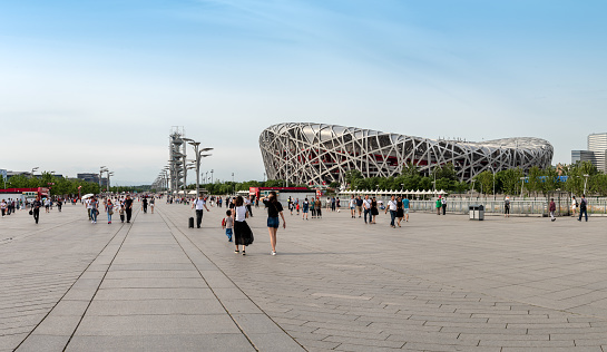 Beijing, China â June 8 2018: People walking at the Olympic park near the birds nest stadium in Beijing China