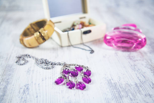 woman accessories with perfume on desk