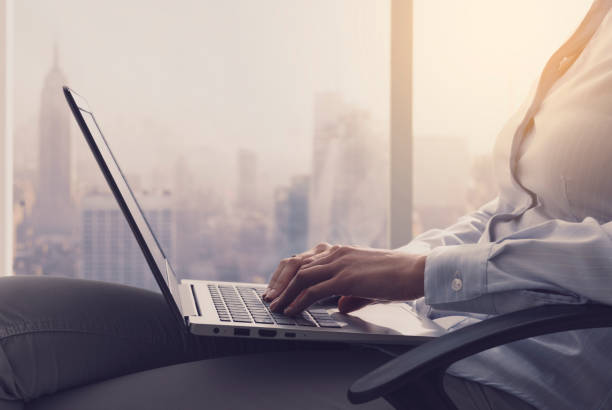 istock Businesswoman working with a laptop next to a window 1134970464