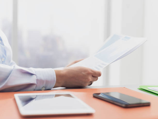istock Businesswoman checking financial reports and statements 1134970484