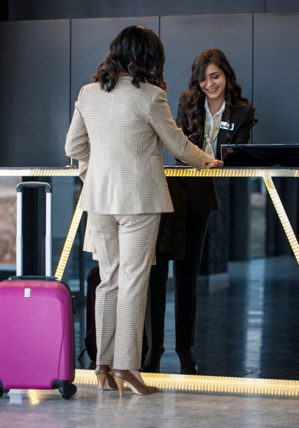 istock Businesswoman Checking In At Hotel Reception 1134975495