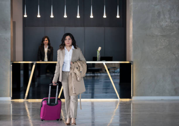 istock Businesswoman pulling her luggage and leaving hotel 1134975657