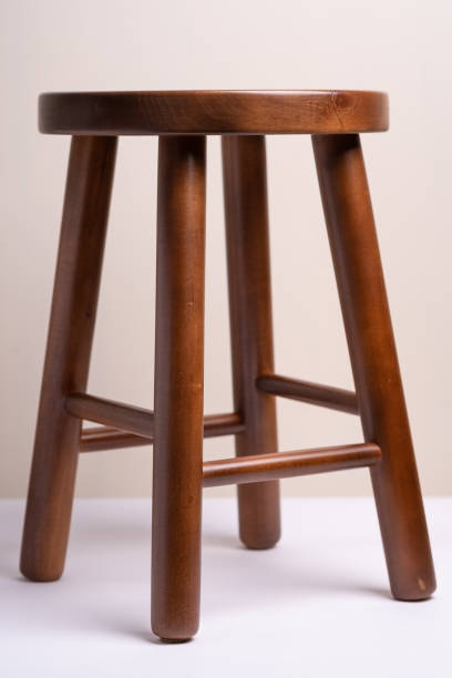 istock Handcrafted dark brown wooden backless stool on white background isolated 1134977621