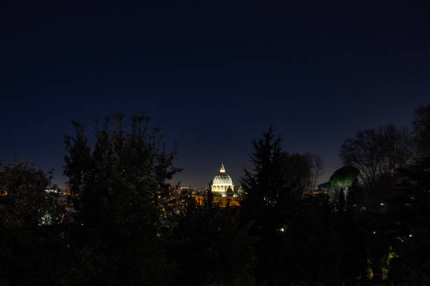 Vatican, Vatican City - December 7, 2023: St Peter's Basilica and St Peter's Square against night sky in Vatican City, Rome, Italy