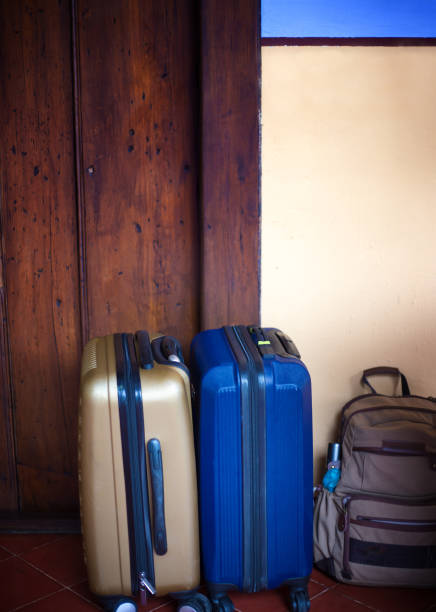 istock On Vacation: Wheeled Suitcases and Backpack Near Door 1134984239