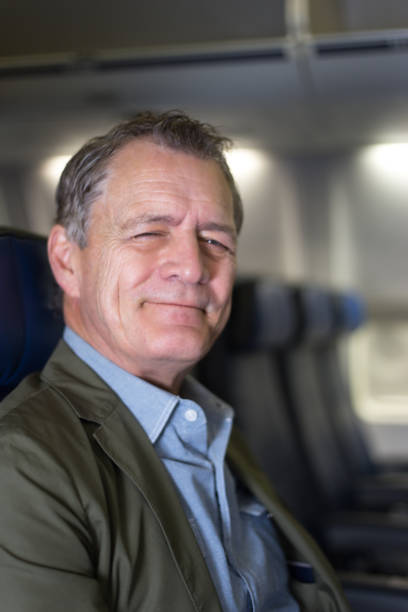istock Happy Active Senior Man on Plane Smiling at Camera 1134984289