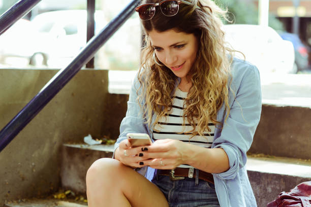 istock Young woman sending message with smartphone. 1134984386