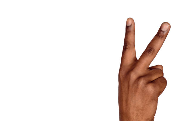 istock Man hand victory sign gesture 1134984399