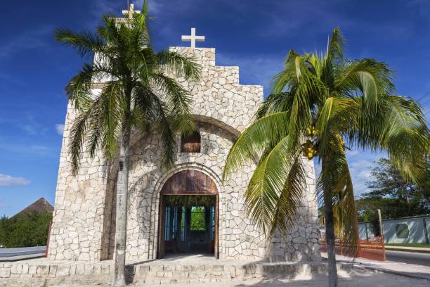 Capilla Santa Cruz Catholic Church and Palm Trees on Cozumel Waterfront Capilla Santa Cruz Catholic Church Building Exterior on Waterfront near San Miguel Downtown on Cozumel Island, Mexico san miguel de cozumel stock pictures, royalty-free photos & images