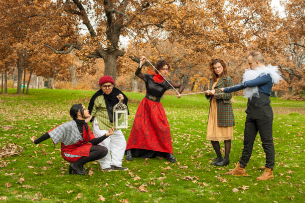 Group of young actors characters performance. Outdoors. Environmental