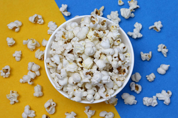 istock Pot of popcorn on blue and yellow background 1134986905