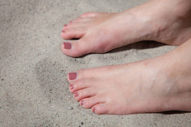 istock Woman's feet and toes playing in sand 1134995370