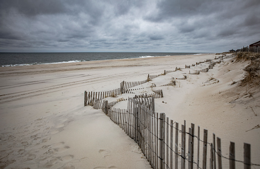 Looking down the beach in the Hamptons with a dramatic sky
