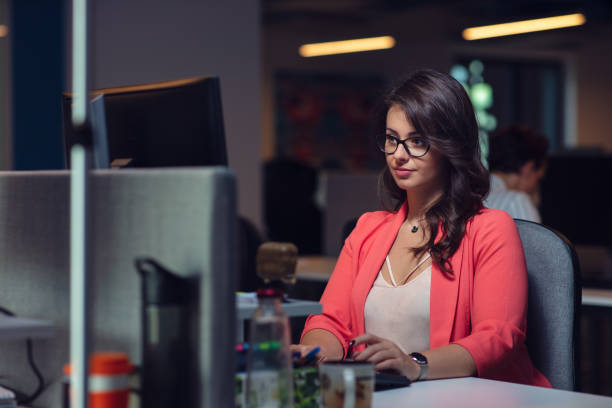 istock Beautiful business lady with laptop computer in office. 1134996861