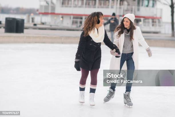 Adult Female Couple Ice Skating Stock Photo - Download Image Now - Ice-skating, Winter, Ice Rink