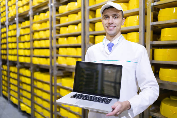 istock Worker shows an empty screen laptop in stock cheese 1134998352