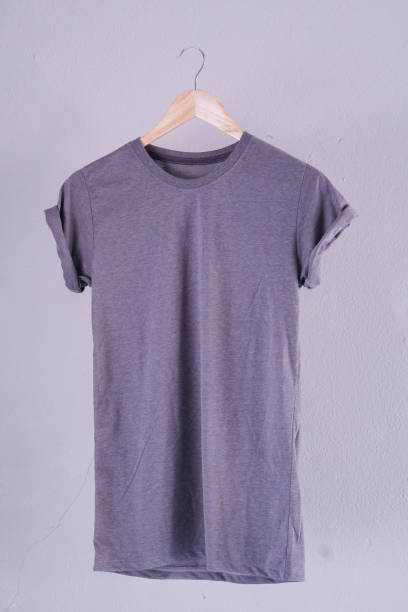 istock Retro fold grey cotton T-Shirt clothes mock up template on gray cement background concept for retail dress shop backdrop, Blank flat lay vintage grey wall plain laundry advertising 1134998429