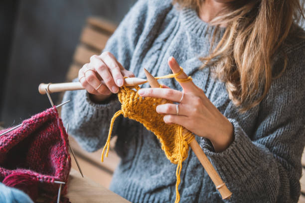 istock Close up on woman's hands knitting 1134998437