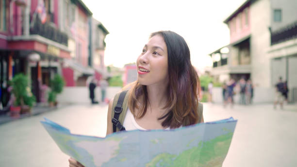 istock Cheerful beautiful young Asian backpacker woman direction and looking on location map while traveling at Chinatown in Beijing, China. Lifestyle backpack tourist travel holiday concept. 1134998507