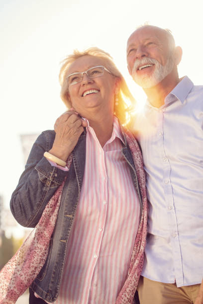 istock Happy nice mature couple walking in town 1135002555